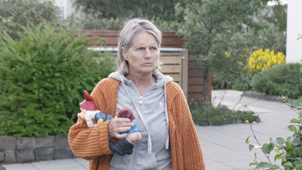 Inga (Edda Björgvinsdóttir) refuses to cut down the tree which casts a shadow on her neighbors' yard, causing conflict to brew. Press photo. Inga (Edda Björgvinsdóttir) refuses to cut down the tree which casts a shadow on her neighbors' yard, causing conflict to brew. Press photo.