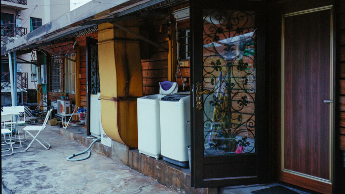 A provisional solution: washing machines sit outside a rooftop apartment. A provisional solution: washing machines sit outside a rooftop apartment.