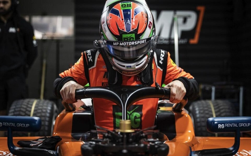 FLAGGING FOR VICTORY: Dennis Hauger in the cockpit, with a helmet dedicated to his country.