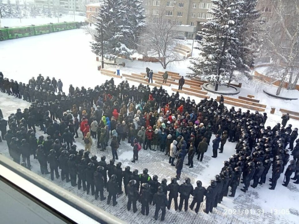 Police surround a group of protesters in winter 2021.